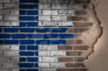 Dark brick wall texture with plaster - flag painted on wall - Finland