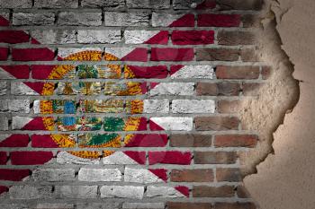 Dark brick wall texture with plaster - flag painted on wall - Florida