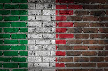 Very old dark red brick wall texture with flag - Italy