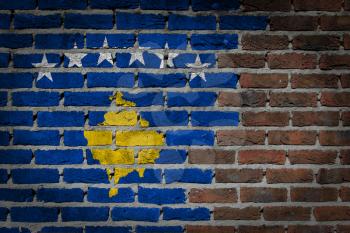 Very old dark red brick wall texture with flag - Kosovo