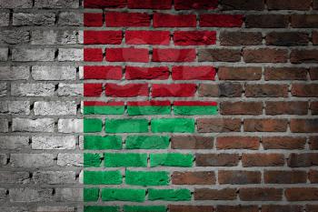 Very old dark red brick wall texture with flag - Madagascar