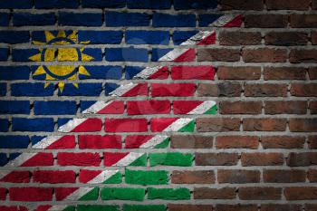 Very old dark red brick wall texture with flag - Namibia