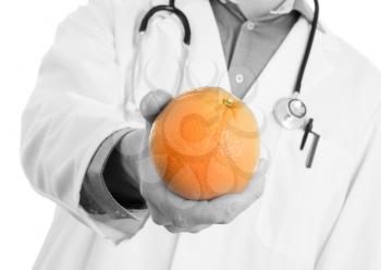 Nutritionist doctor, giving an orange, isolated on white