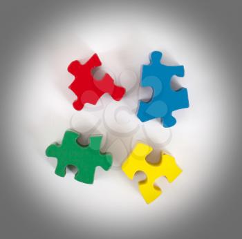 Closeup of 4 big jigsaw puzzle pieces isolated on white