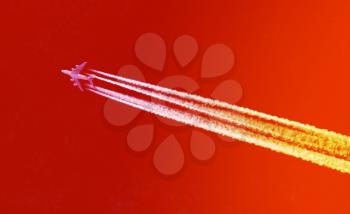 Large aircraft flying in sky, 4 stripes in the sky - Bright red and orange sky