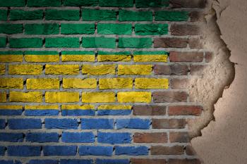 Dark brick wall texture with plaster - flag painted on wall - Gabon