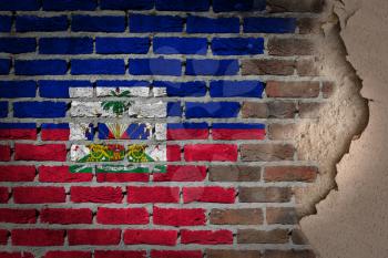 Dark brick wall texture with plaster - flag painted on wall - Haiti