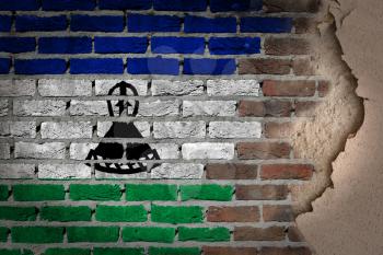 Dark brick wall texture with plaster - flag painted on wall - Lesotho