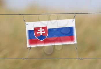 Border fence - Old plastic sign with a flag - Slovakia