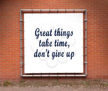 Large banner with inspirational quote on a brick wall - Great things take time, don't give up
