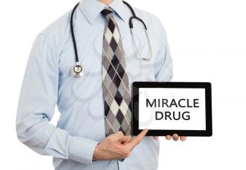 Doctor, isolated on white backgroun,  holding digital tablet - Miracle drug