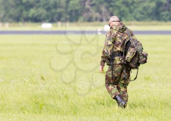 LEEUWARDEN, THE NETHERLANDS - JUNE 9; Military guard walking at the runway during the Royal Netherlands Air Force Days.