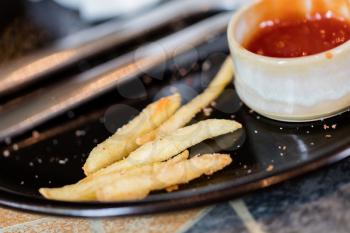 French fries, leftover from a lunch - Selective focus