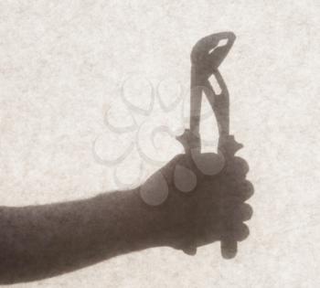 Silhouette behind a transparent paper - Pipe wrench
