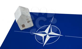 Small house on a flag - Living or migrating to NATO