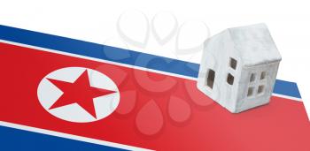 Small house on a flag - Living or migrating to North Korea