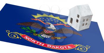 Small house on a flag - Living or migrating to North Dakota