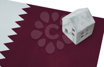 Small house on a flag - Living or migrating to Qatar
