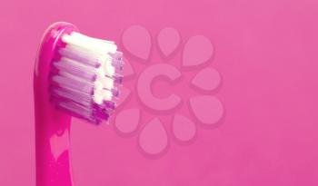 Dental care toothbrush isolated on pink background