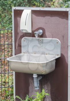Metal sink outside - Washing your hands with soap