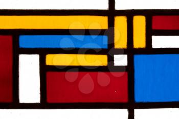 Image of a multicolored stained glass window with irregular block pattern