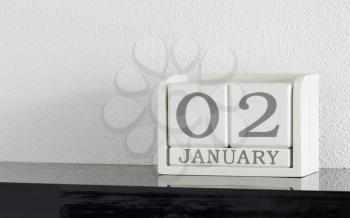 White block calendar present date 3 and month January on white wall background