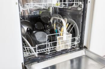 Open dishwasher with clean plates, cups and dishes - Selective focus