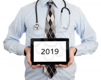 Doctor holding blank digital tablet with copy space and clipping path for the screen - 2019