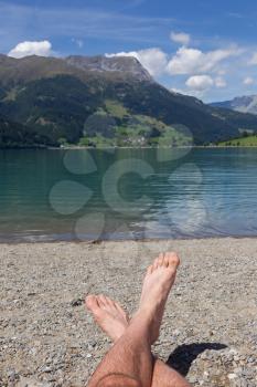 Feet on the beach, relaxing at the Reschensee - Italy