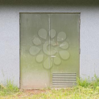 Concrete storage box in the Alps - Big metal doors