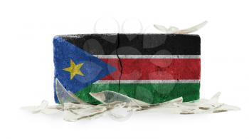 Brick with broken glass, violence concept, flag of South Sudan