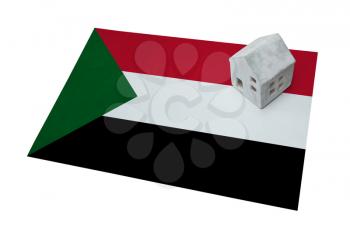Small house on a flag - Living or migrating to Sudan