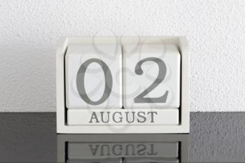 White block calendar present date 3 and month August on white wall background
