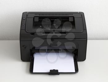 Compact laser home printer on a white desk