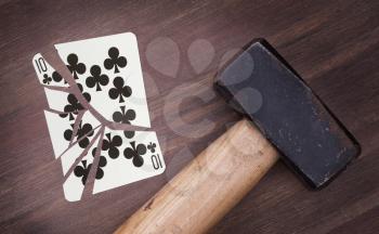 Hammer with a broken card, vintage look, ten of clubs