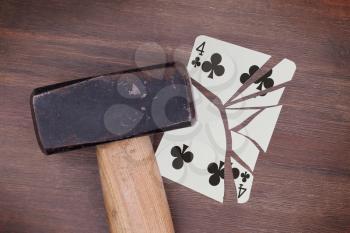 Hammer with a broken card, vintage look, four of clubs