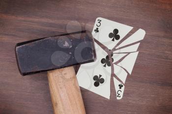 Hammer with a broken card, vintage look, three of clubs