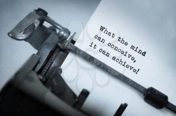 Vintage inscription made by old typewriter, What the mind can conceive it can achieve