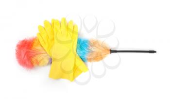 Yellow cleaning gloves with a duster - isolated on white