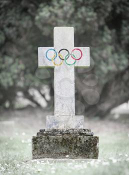 Old weathered gravestone in the cemetery - Olympic rings