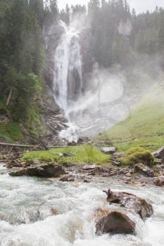 Waterfall in the forest, raging water in Switzerland