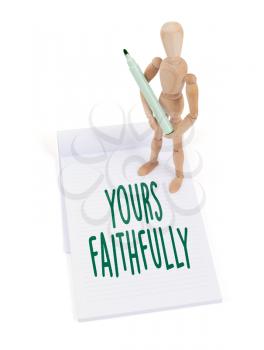 Wooden mannequin writing in a scrapbook - Yours faithfully