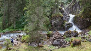 Hiker, young woman with backpack walking on footpath, Switzerland