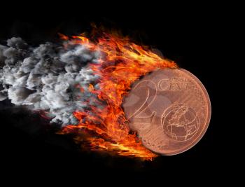 Burning coin with a trail of fire and smoke - 2 eurocent