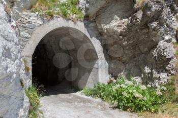 Small dark tunnel in a Swiss mountain