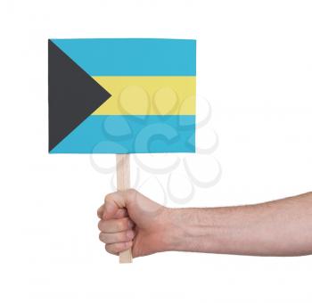Hand holding small card, isolated on white - Flag of Bahamas