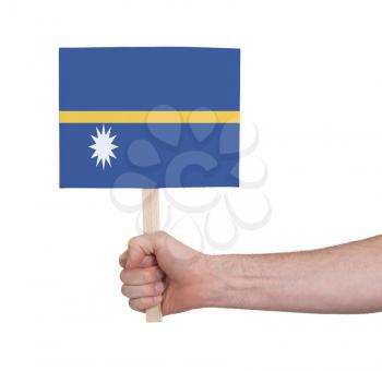 Hand holding small card, isolated on white - Flag of Nauru