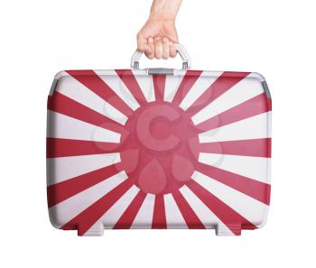 Used plastic suitcase with stains and scratches, printed with flag - Japan