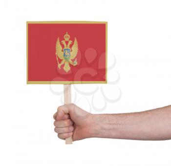 Hand holding small card, isolated on white - Flag of Montenegro