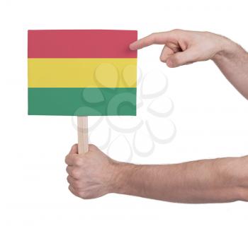 Hand holding small card, isolated on white - Flag of Bolivia